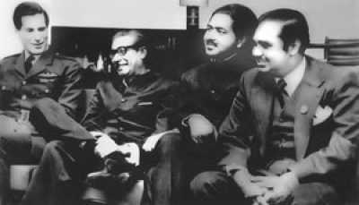 At Nicosia airport, Cyprus, January 9, 1972, en route from London to Dhaka after release. (left to right): Air Commodore David B Craig, UK Royal Air Force, Sheikh Mujibur Rahman, PM elect of Bangladesh, Dr Kamal Hossain, Minister for Law and Parliamentary Affairs, Golam Mowla, Managing Director of Great Eastern Insurance Company Limited. 