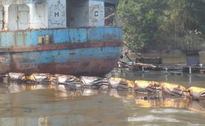 The rescued tanker surrounded by rubber boom.