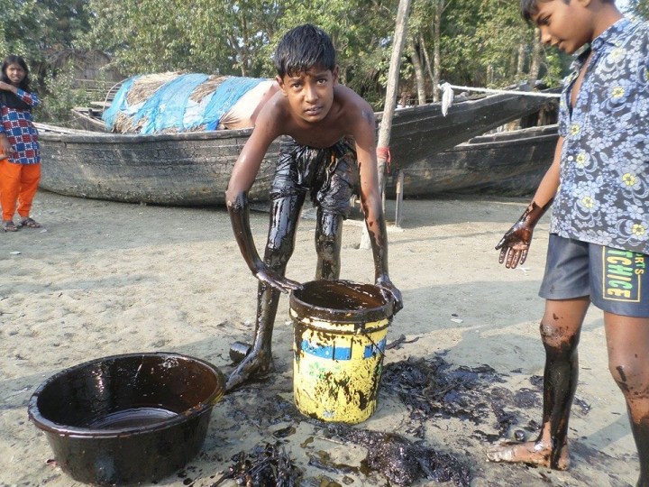 Kids and youths are picking up the oil with their bare hands.